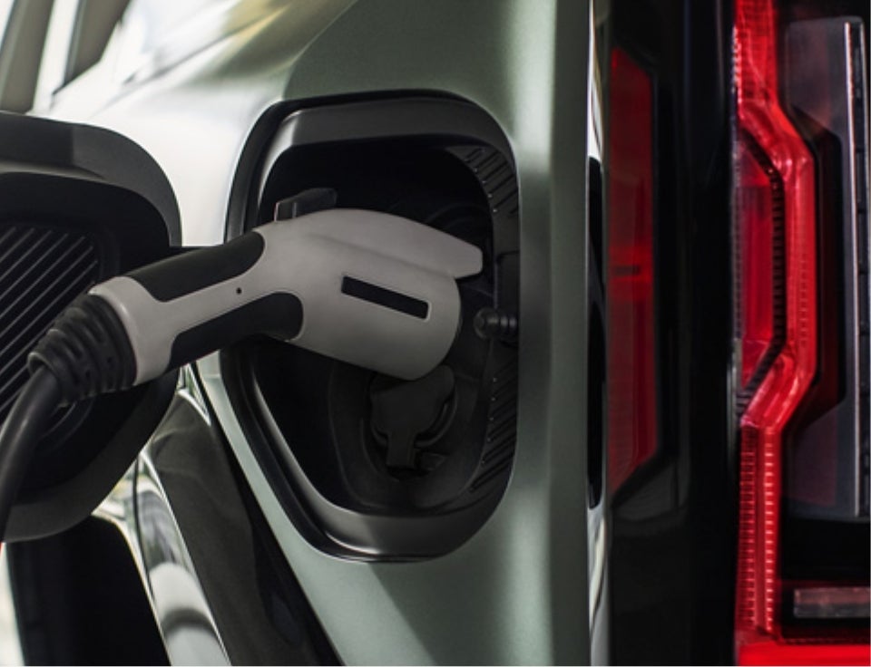 Close up of charging port with charger plugged in on a GMC Hummer EV SUV - GMC of Watertown in Watertown CT
